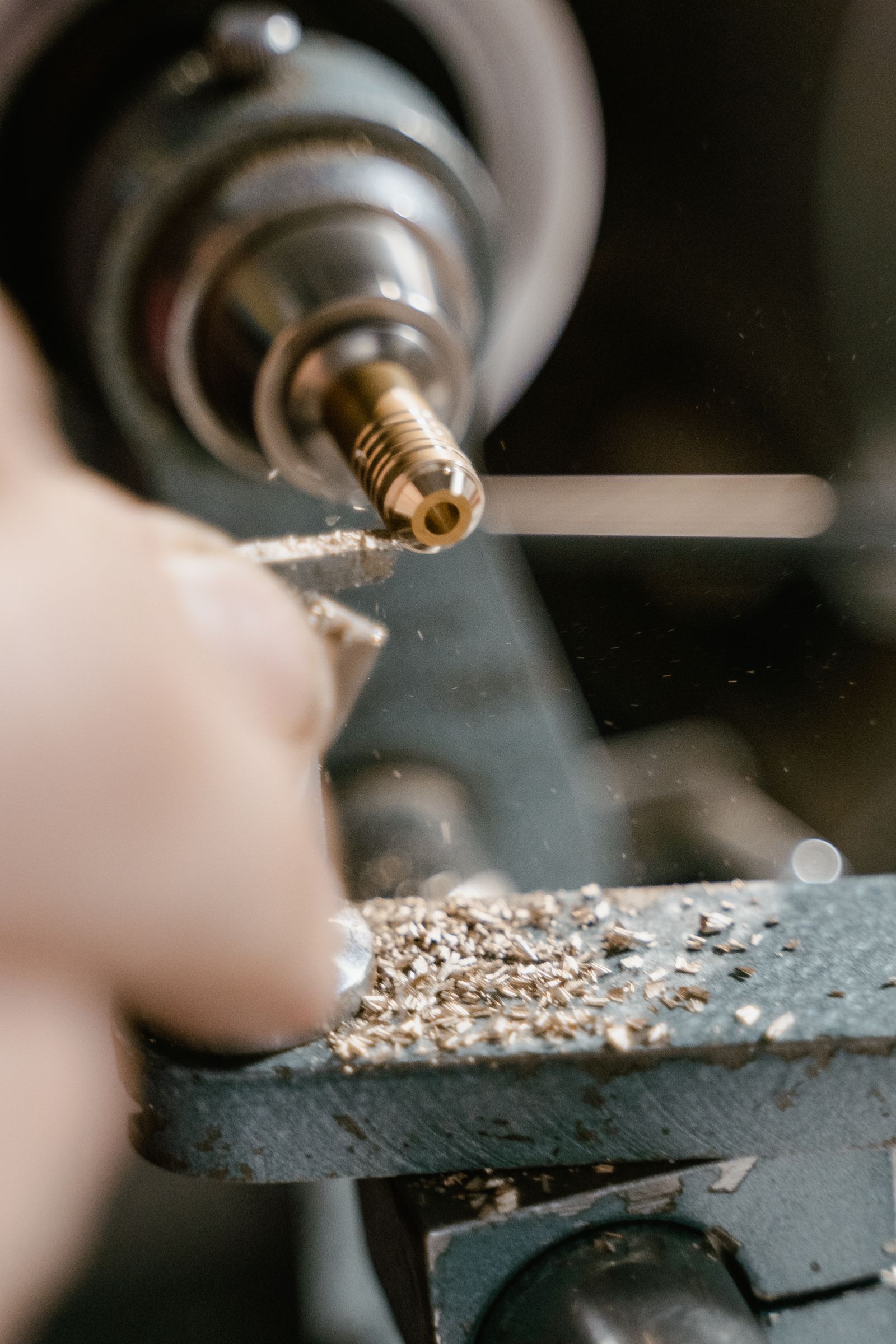 Brass turned part being machined on a CNC lathe